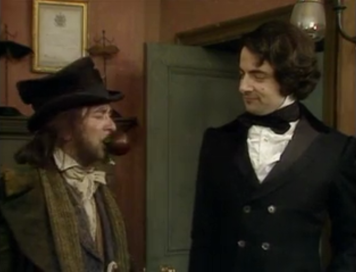 Rowan Atkinson as Ebenezer Blackadder and Tony Robinson as Baldrick with a Christmas pudding in Blackadder's Christmas Carol