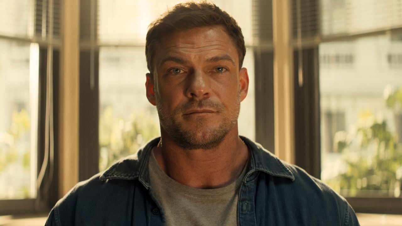 Alan Ritchson as Jack Reacher in a denim shirt in a still from Reacher Season 4